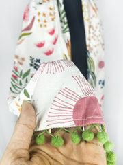 White Botanical Print Scarf with Green Pom-Pom Trim – Vibrant Floral Accessory