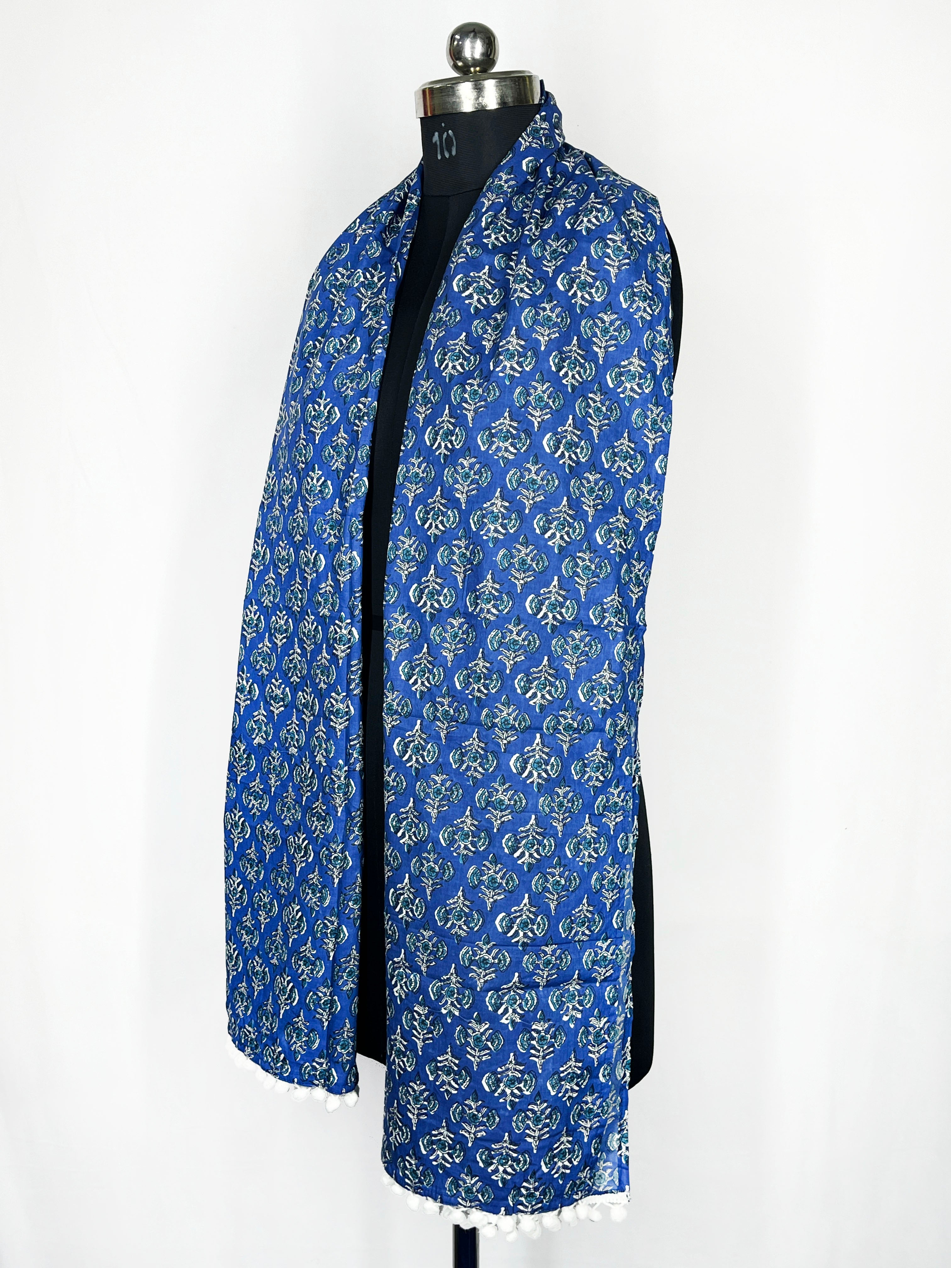 Pom-pom trim and an intricate paisley print adorn this royal blue scarf 22x72 Inch