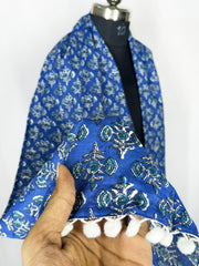 Pom-pom trim and an intricate paisley print adorn this royal blue scarf 22x72 Inch