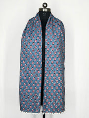 Pom-pom edging and a blue floral print scarf make this accessory lightweight and fashionable