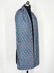 Pom-pom edging and a blue floral print scarf make this accessory lightweight and fashionable