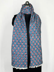 Pom-pom edging and a blue floral print scarf make this accessory lightweight and fashionable